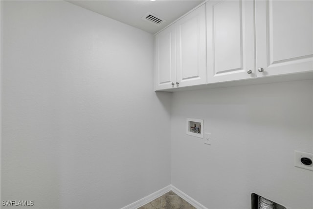 clothes washing area with cabinets, hookup for a washing machine, and electric dryer hookup