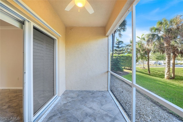 unfurnished sunroom with a wealth of natural light and ceiling fan