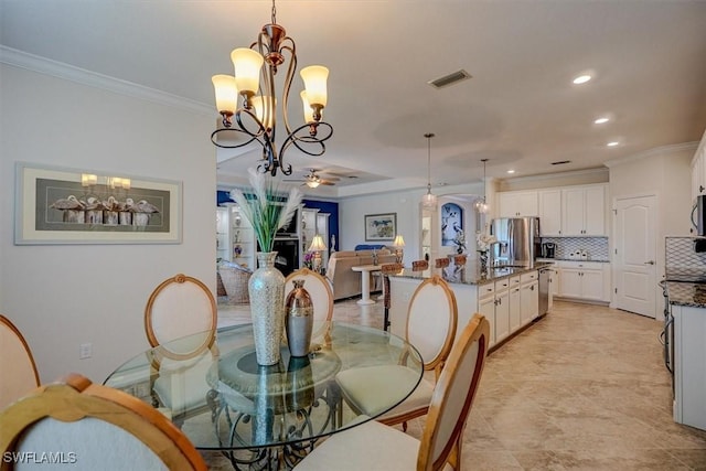 dining room featuring crown molding and ceiling fan with notable chandelier