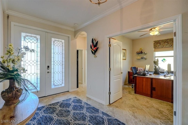 foyer entrance with ornamental molding, ceiling fan, and french doors