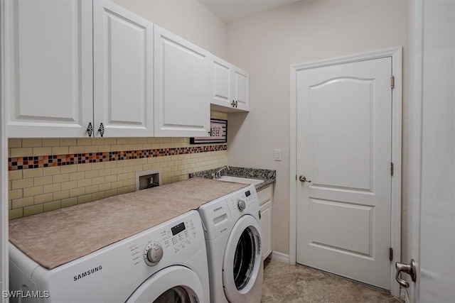 laundry room with cabinets, sink, and washing machine and dryer