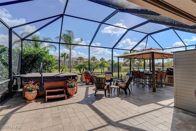 view of patio featuring a hot tub, a lanai, and a bar