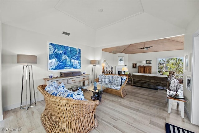 living room featuring vaulted ceiling, ceiling fan, and light hardwood / wood-style floors