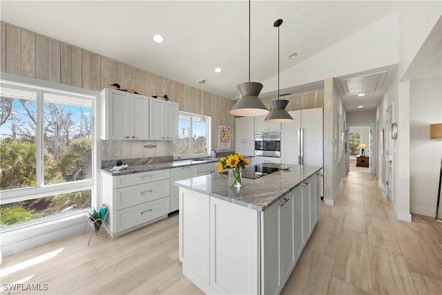 kitchen featuring white cabinetry, hanging light fixtures, and a kitchen island