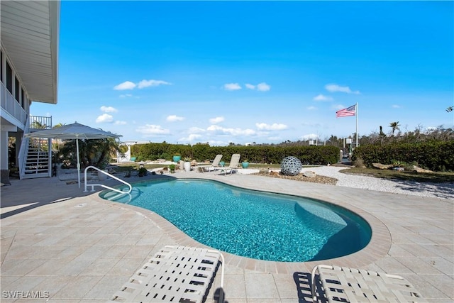 view of swimming pool with a patio area