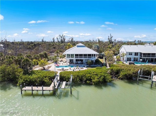 rear view of property with a water view