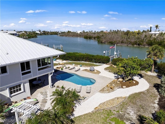 view of pool with a patio area and a water view