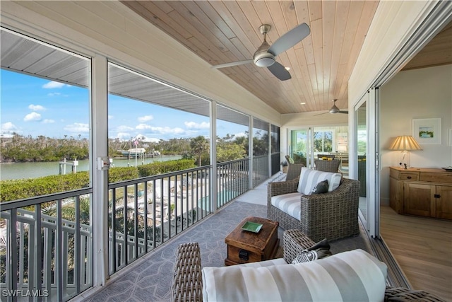 sunroom featuring a water view, ceiling fan, and wood ceiling