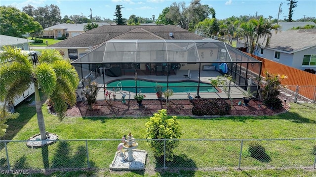 exterior space featuring a lanai, a lawn, and a patio