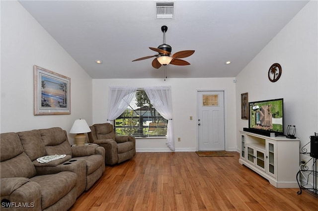 living room with vaulted ceiling, light hardwood / wood-style floors, and ceiling fan