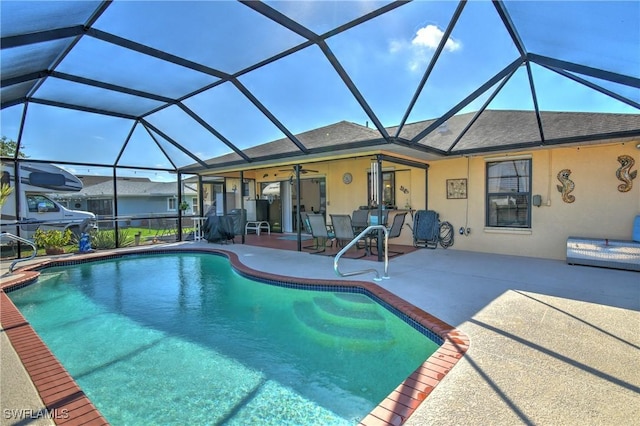 view of swimming pool featuring ceiling fan, a patio, and glass enclosure