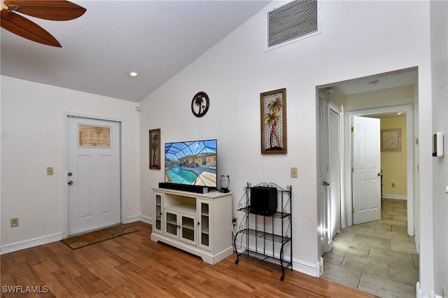 living room featuring ceiling fan, hardwood / wood-style floors, and high vaulted ceiling