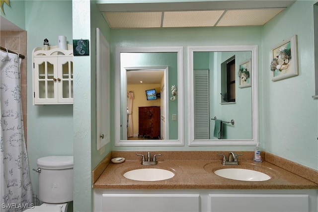 bathroom featuring vanity, toilet, and a shower with shower curtain