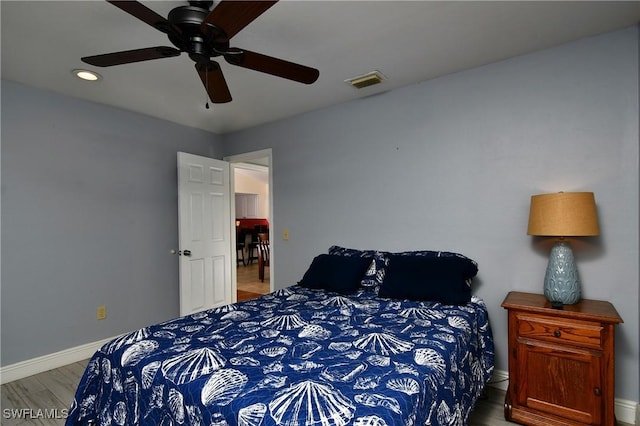 bedroom with wood-type flooring and ceiling fan