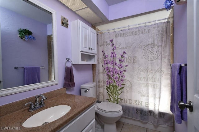 bathroom with tile patterned flooring, vanity, and toilet