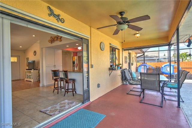 sunroom / solarium with ceiling fan