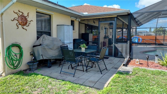 view of patio with ceiling fan, a lanai, and a fenced in pool