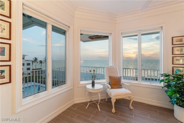 sunroom / solarium featuring a water view