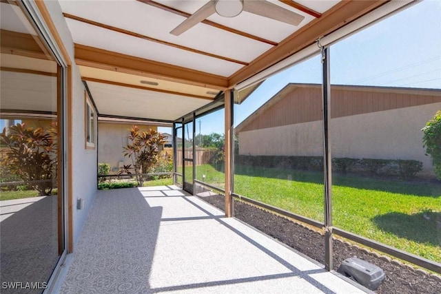 unfurnished sunroom with ceiling fan