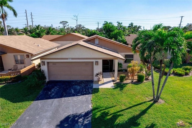 view of front of property with a garage and a front yard