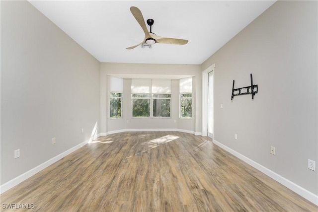 spare room featuring hardwood / wood-style flooring and ceiling fan