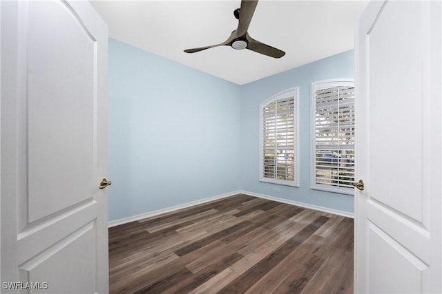 unfurnished room with dark hardwood / wood-style flooring and ceiling fan