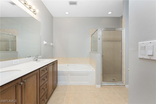 bathroom featuring independent shower and bath, vanity, and tile patterned floors