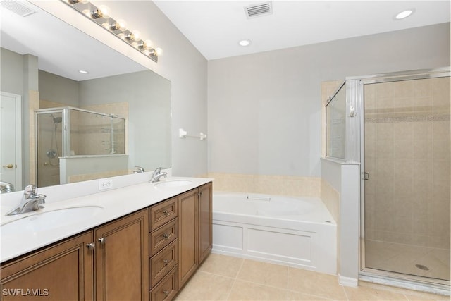 bathroom with tile patterned floors, independent shower and bath, and vanity