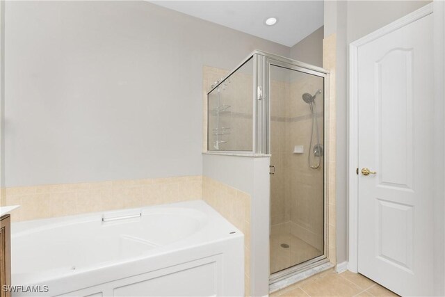 bathroom with tile patterned floors, plus walk in shower, and vanity