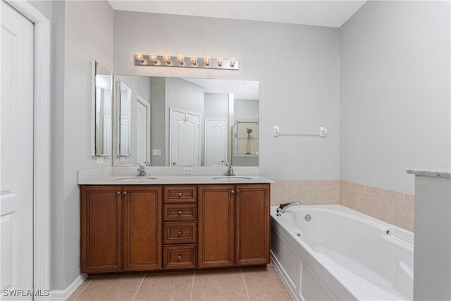 bathroom with tile patterned flooring, vanity, and separate shower and tub