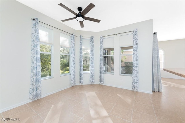 unfurnished sunroom featuring ceiling fan