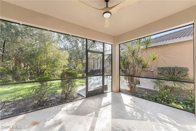 unfurnished sunroom featuring ceiling fan