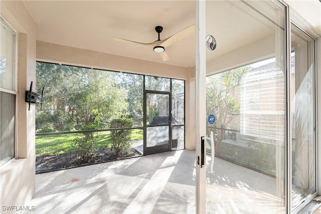 unfurnished sunroom with a ceiling fan