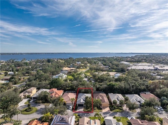 drone / aerial view with a water view and a residential view