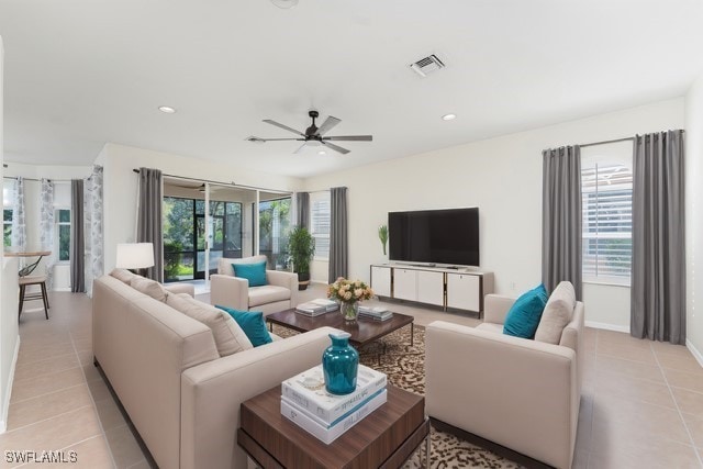 living area featuring light tile patterned floors, recessed lighting, visible vents, and a healthy amount of sunlight