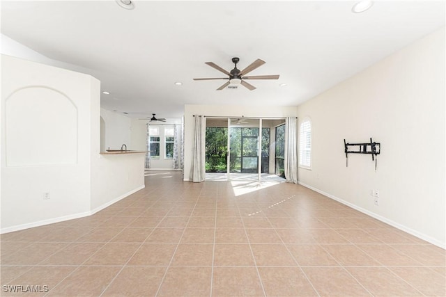 spare room with light tile patterned floors, recessed lighting, a ceiling fan, and baseboards