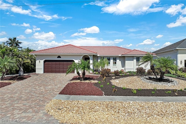 mediterranean / spanish house with a garage