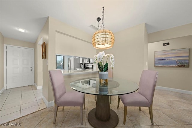 dining room featuring light tile patterned flooring and sink