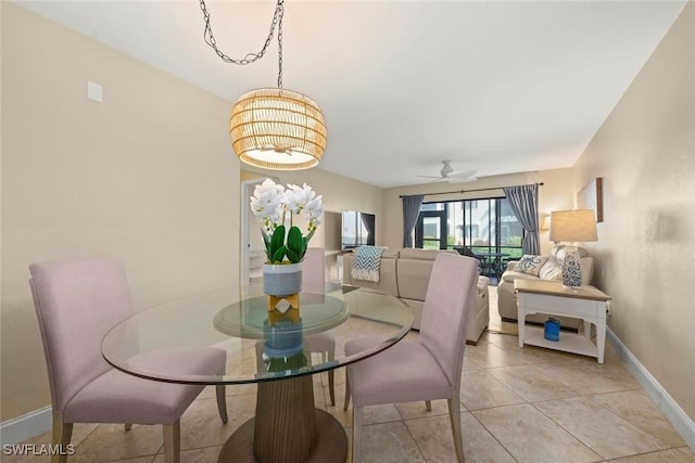 dining area featuring light tile patterned floors and ceiling fan