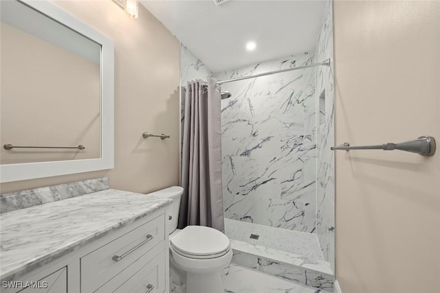 bathroom featuring vanity, curtained shower, and toilet