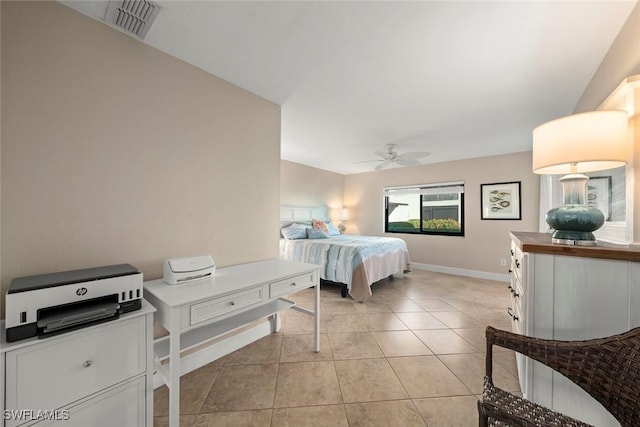 tiled bedroom featuring ceiling fan