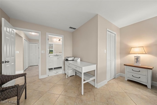 office space featuring light tile patterned flooring and sink