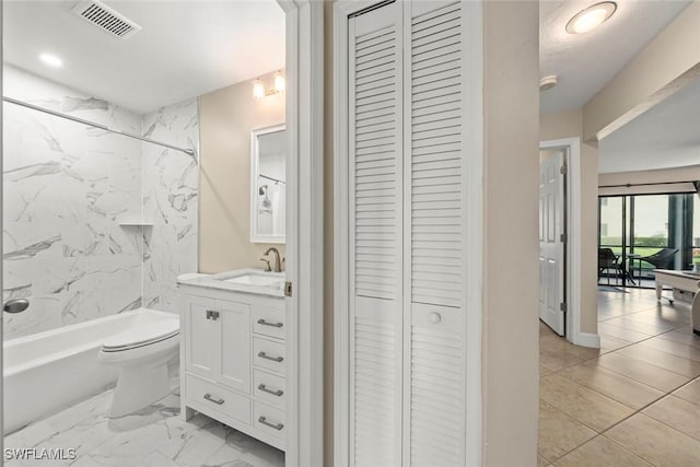 full bathroom with vanity, tiled shower / bath, and toilet