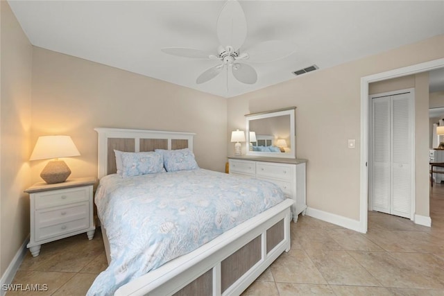 tiled bedroom featuring ceiling fan