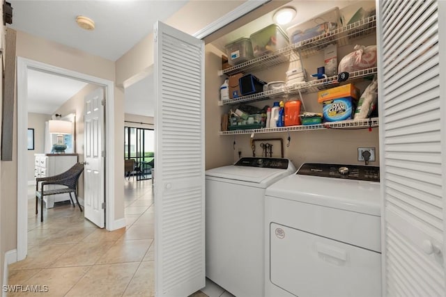 laundry room with separate washer and dryer and light tile patterned floors