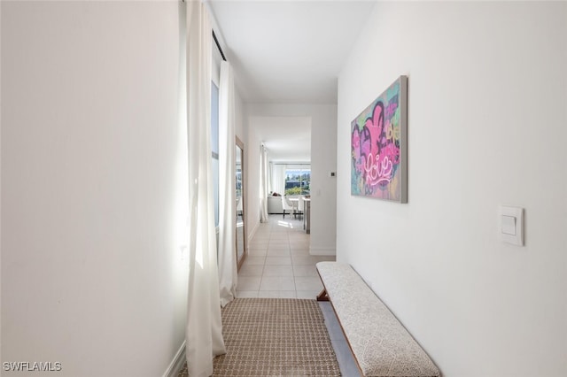 corridor featuring light tile patterned floors