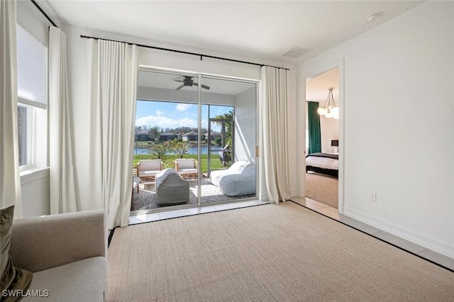 bedroom featuring a water view and access to exterior