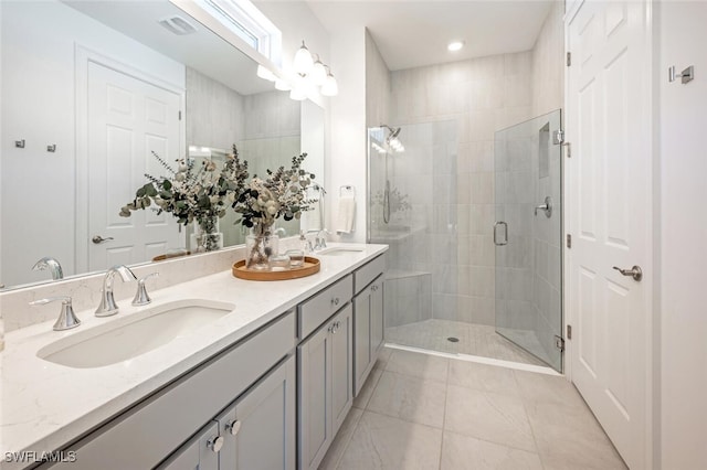 bathroom featuring tile patterned flooring, vanity, and an enclosed shower