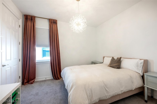 carpeted bedroom with an inviting chandelier