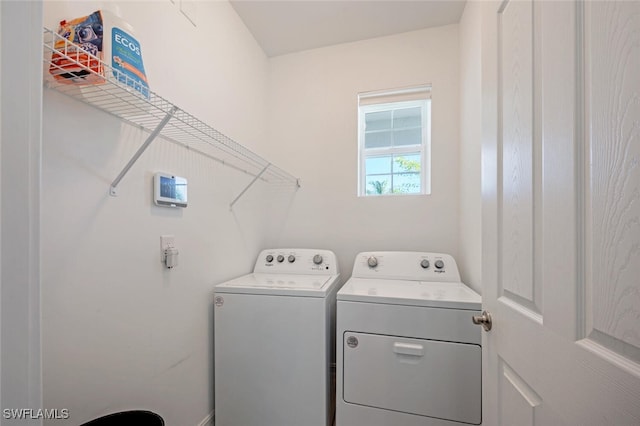 clothes washing area with washer and dryer